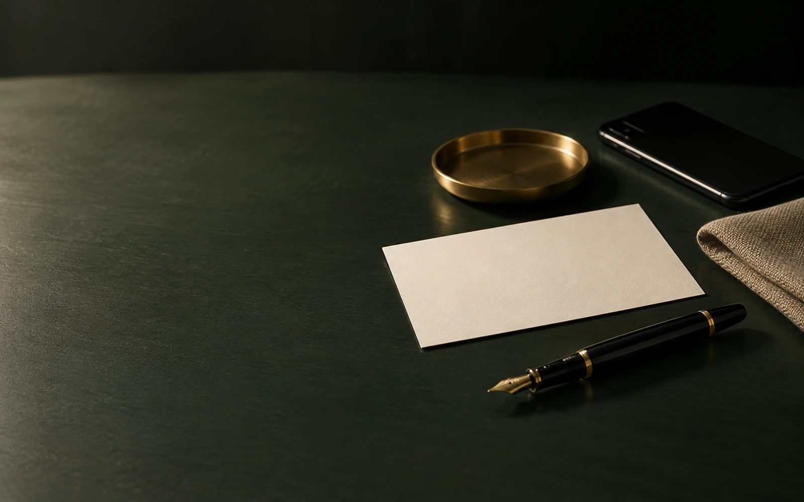 Elegant desk with correspondence card, pen, phone and fabric swatch ready for an enquiry